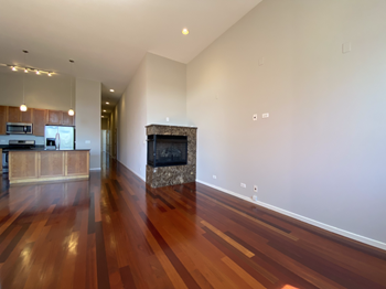Spacious living area with hardwood floors and a built-in fireplace